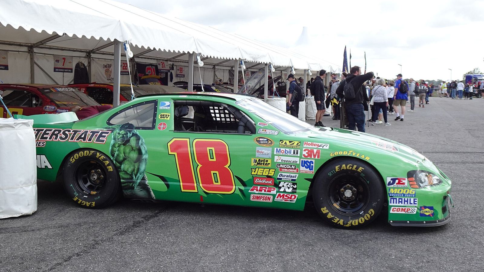 Bobby Labonte's green No. 18 Interstate Batteries Pontiac in a paddock