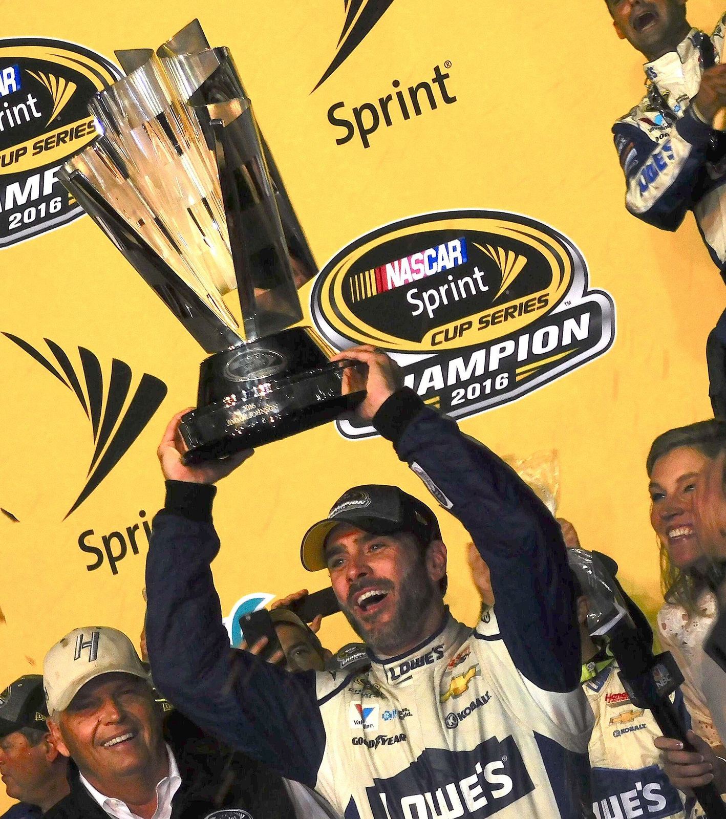 Jimmie Johnson lifting the Cup Series championship trophy at Homestead in 2016